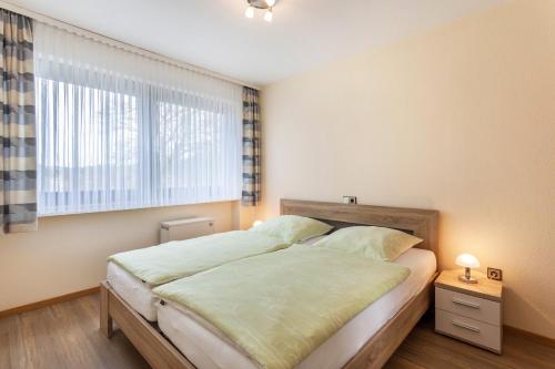 a bedroom with a bed and a window at Ferienwohnung Figelius in Herscheid