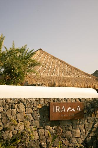 a sign on the side of a building at Irama Surf Villas - Private Pool Villas at Yoyos in Sekongkang