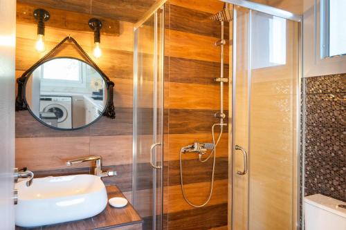 a bathroom with a shower and a sink at Mont' Rock villas 2 in Posidhonía