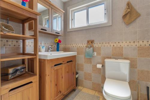 a bathroom with a toilet and a sink at Penthouse con Jacuzzi in Costa Teguise