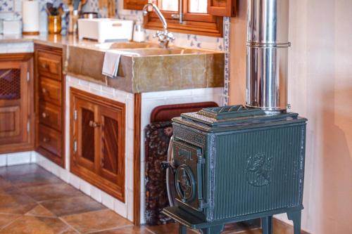 a kitchen with an old stove and a sink at Son Garrot in Santanyi