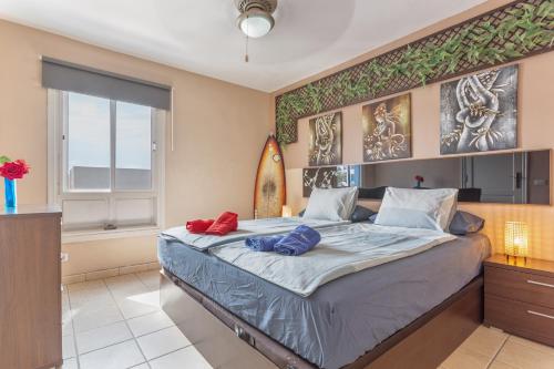 a bedroom with a bed with a surfboard on it at Penthouse con Jacuzzi in Costa Teguise