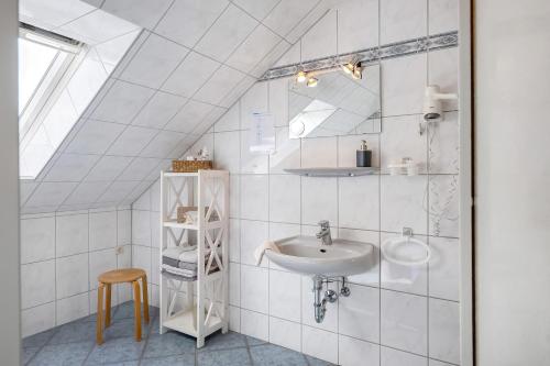 a bathroom with a sink and a mirror at Wohnung Hallighof in Honkenswarft