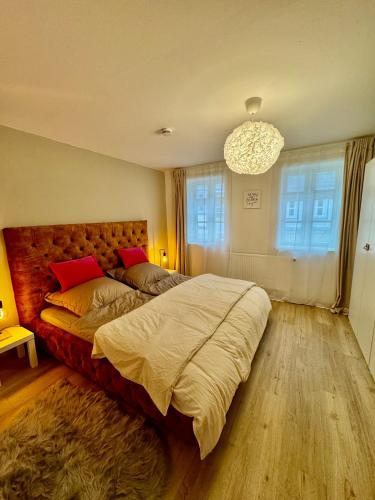 a bedroom with a large bed and a chandelier at Wohnung In Wolfenbüttel in Wolfenbüttel