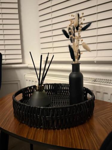 a table with two black vases on top of it at Seaside studio apartment in Weston-super-Mare