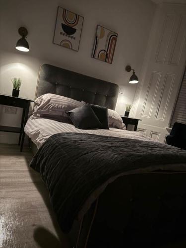 a bedroom with a large bed with two pillows at Seaside studio apartment in Weston-super-Mare