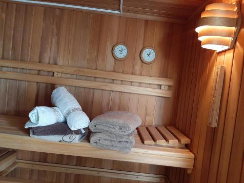 a sauna with towels and clocks on the wall at Ferienhaus mit Schwimmhalle in Burgthann