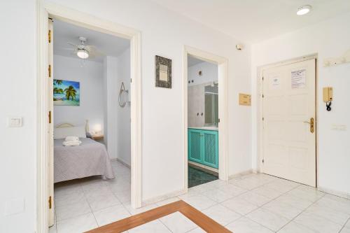 a room with a bedroom and a bed and a door at Nerja Vacaciones Apartamentos in Nerja