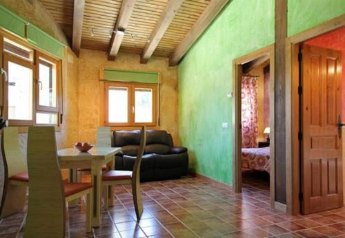a living room with a couch and a table at El Mirador De Campumedra in Vadillo