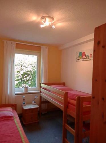 a bedroom with two bunk beds and a window at Heidtschmidhof Abendsonne in Wolgast