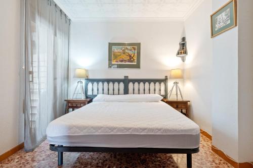 a bedroom with a bed and two night stands at Ático Cesar Cataldo in Benicarló