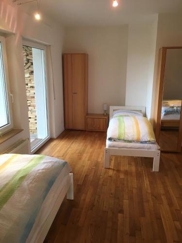 a bedroom with two beds and a mirror at Ferienwohnung Am Sieperloh in Stryck