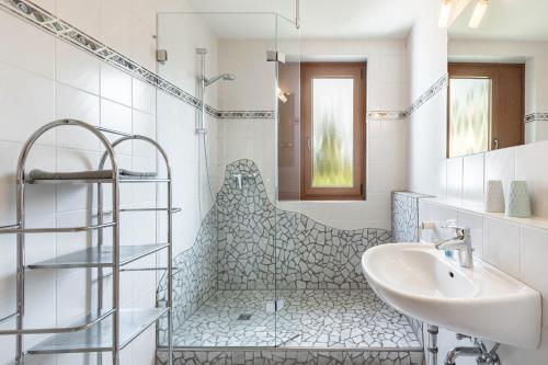 a white bathroom with a sink and a shower at Appartmenthaus Felicitas in Willingen