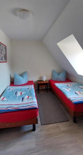 a room with two beds in a attic at Müritz - Domizil in Waren