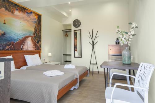 a bedroom with a bed and a desk and a table at Motel katerina in Keratea