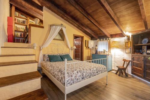 a bedroom with a bed in a room with wooden ceilings at Casa Palmera - Private Paradise in Tacoronte