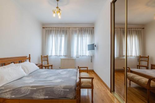 a bedroom with a bed and a mirror at Piso Calle Sarria in Monforte de Lemos