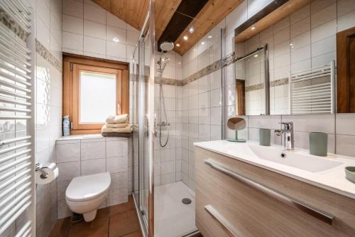 a bathroom with a toilet and a sink and a shower at Appartement chalet - Le Caribou in Morzine