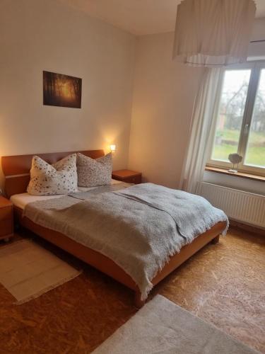 a bedroom with a large bed and a window at Ferienwohnung Pieck in Raduhn