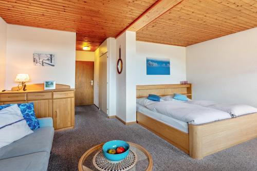 a bedroom with two beds and a table and a couch at Fidelis-Bühl Muggenbrunn in Todtnau