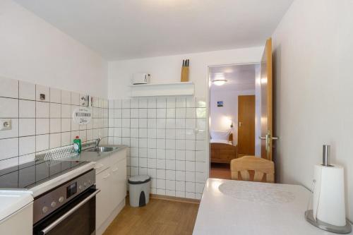 a white kitchen with a sink and a counter at Ferienwohnung Alwine Schulte in Brilon