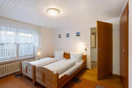 a bedroom with a large bed and a window at Ferienwohnung Alwine Schulte in Brilon
