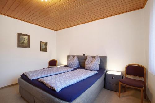 a bedroom with a bed and a wooden ceiling at Fewo Standfuss in Dausenau