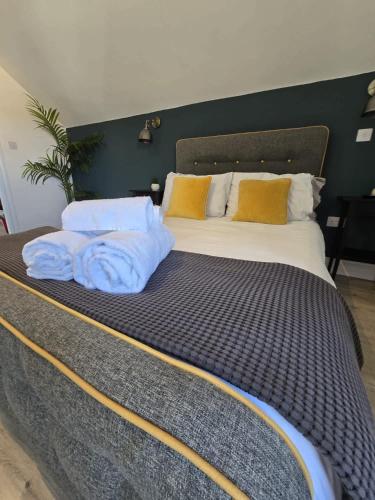 a large bed with two pillows on top of it at 1 Bed Room Flat with sofa Bed, full kitchen in Weston-super-Mare