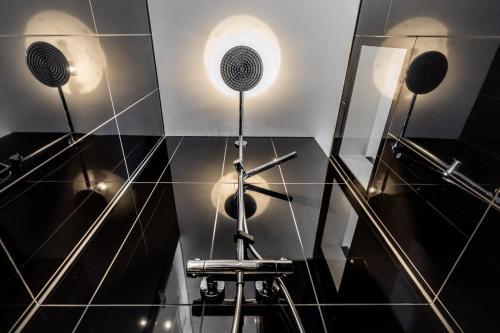 a bathroom with three speakers on the wall at Zollhaus - Doppelzimmer in Endingen