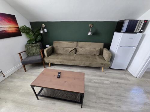 a living room with a couch and a coffee table at 1 Bed Room Flat with sofa Bed, full kitchen in Weston-super-Mare