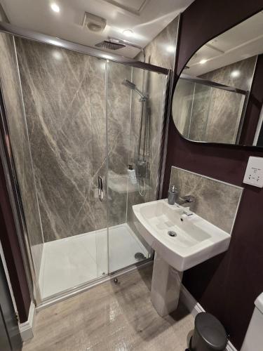 a bathroom with a shower and a sink at 1 Bed Room Flat with sofa Bed, full kitchen in Weston-super-Mare