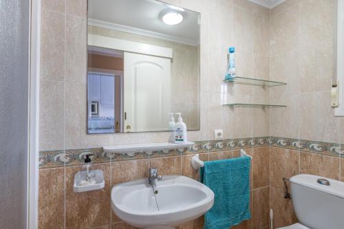 a bathroom with a sink and a mirror at Beautiful duplex in Salobreña in Salobreña