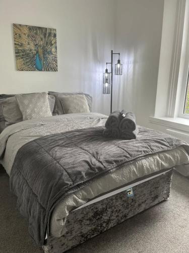 a bed with two stuffed animals on top of it at 1 Bed Flat in Weston-super-Mare