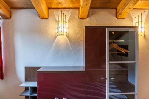 a kitchen with a cabinet and a light on the wall at Panorama Lodge Leutasch mit Sauna in Leutasch