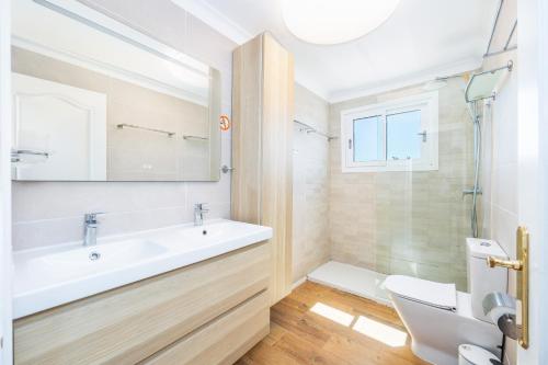 a bathroom with a sink and a toilet and a mirror at Villa Amelia cerca de cala Pi in Llucmajor
