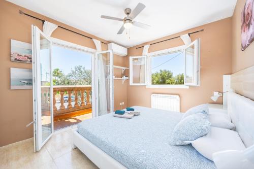 a bedroom with a bed and a large window at Villa Amelia cerca de cala Pi in Llucmajor