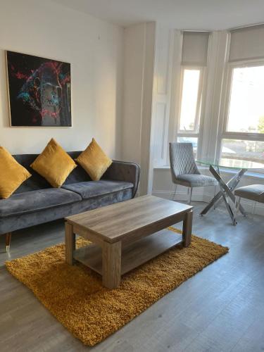 a living room with a couch and a coffee table at Newly Refurbished 1 Bedroom Flat in Weston-super-Mare