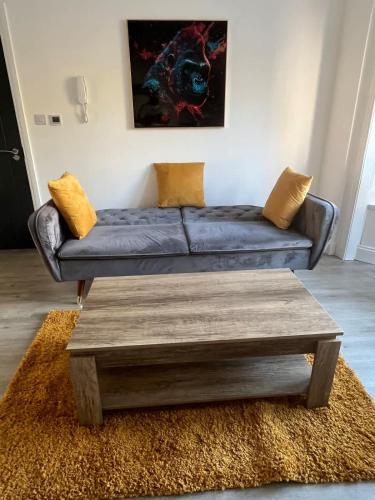 a living room with a couch and a coffee table at Newly Refurbished 1 Bedroom Flat in Weston-super-Mare