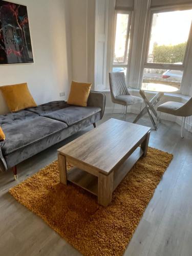 a living room with a couch and a coffee table at Newly Refurbished 1 Bedroom Flat in Weston-super-Mare