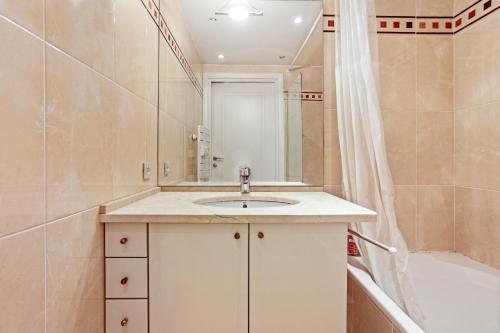 a bathroom with a sink and a shower and a tub at Superbe Appartement vue mer in Fréjus