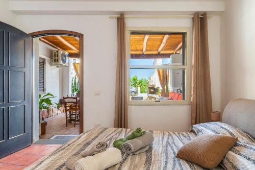 a bedroom with a bed and a large window at Vistamare2 in Cardedu