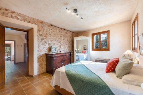 a bedroom with a bed and a dresser at Finca Som Llum in Palma de Mallorca