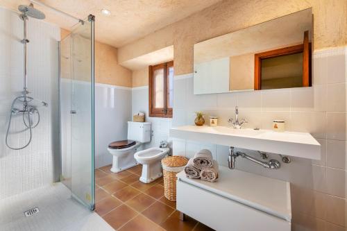 a bathroom with a toilet and a sink and a shower at Finca Som Llum in Palma de Mallorca