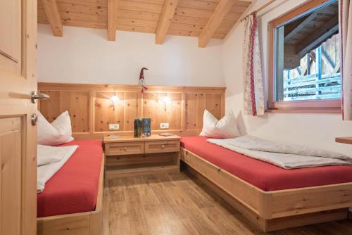 a room with two beds and a window at Schildberghof Ortler in Kastelruth