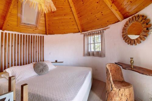 a bedroom with a bed and a wooden ceiling at Casa Moinho Da Eira in Loulé