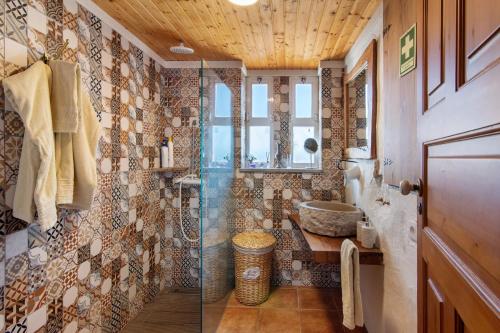 a bathroom with a shower and a sink at Casa Moinho Da Eira in Loulé