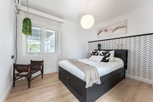 a bedroom with a bed and a chair in it at Villa Sueños in Mijas