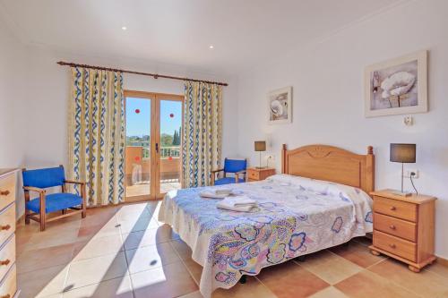 a bedroom with a bed and a table and chairs at Villa Luis Vives in Port de Pollensa