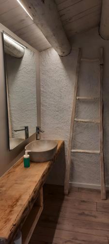 a bathroom with a sink on a wooden counter at El Racó d'Espunyes in Oden