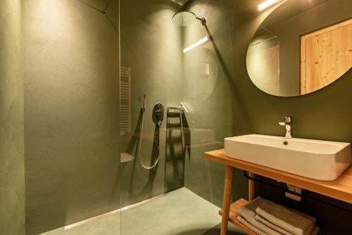a bathroom with a sink and a shower at Hof im Thal Apt Lärche in Aldino
